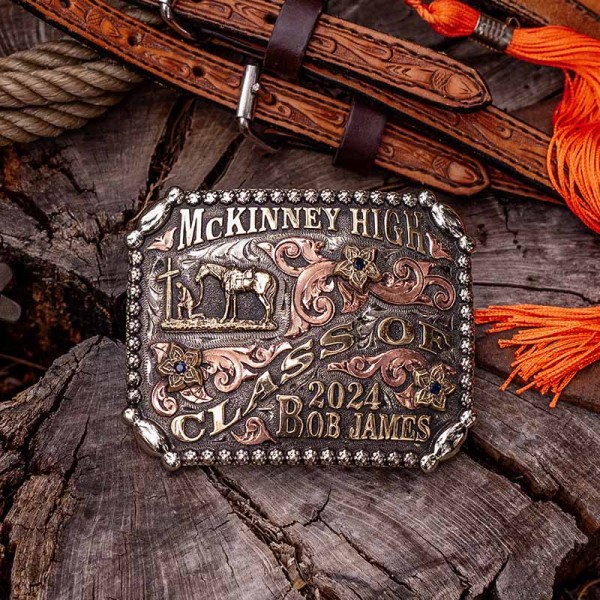 A custom western belt buckle for McKinney High Class of 2024 with personalized name featuring a praying cowboy figure 